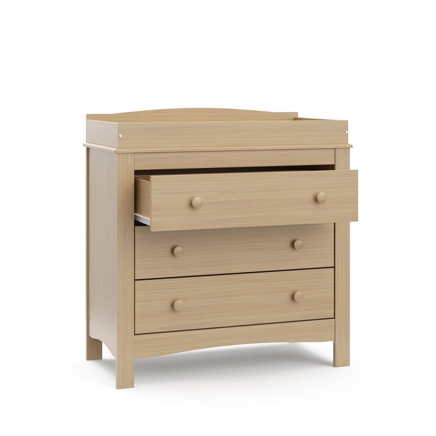 imageGraco Noah 3 Drawer Changing Table Dresser White GREENGUARD Gold Certified Baby Dresser with Changing Table Top Includes Interlocking Drawer SystemDriftwood