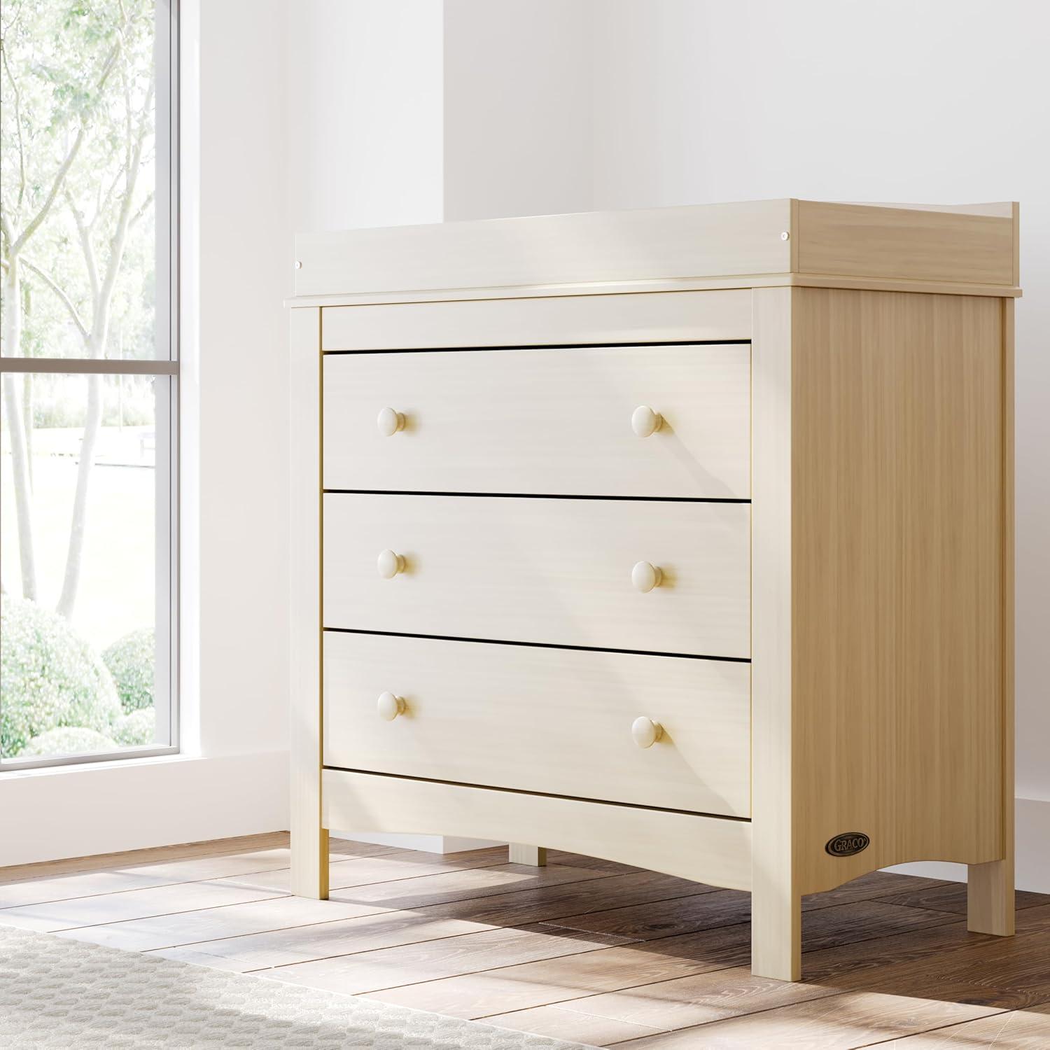 imageGraco Noah 3 Drawer Changing Table Dresser White GREENGUARD Gold Certified Baby Dresser with Changing Table Top Includes Interlocking Drawer SystemDriftwood
