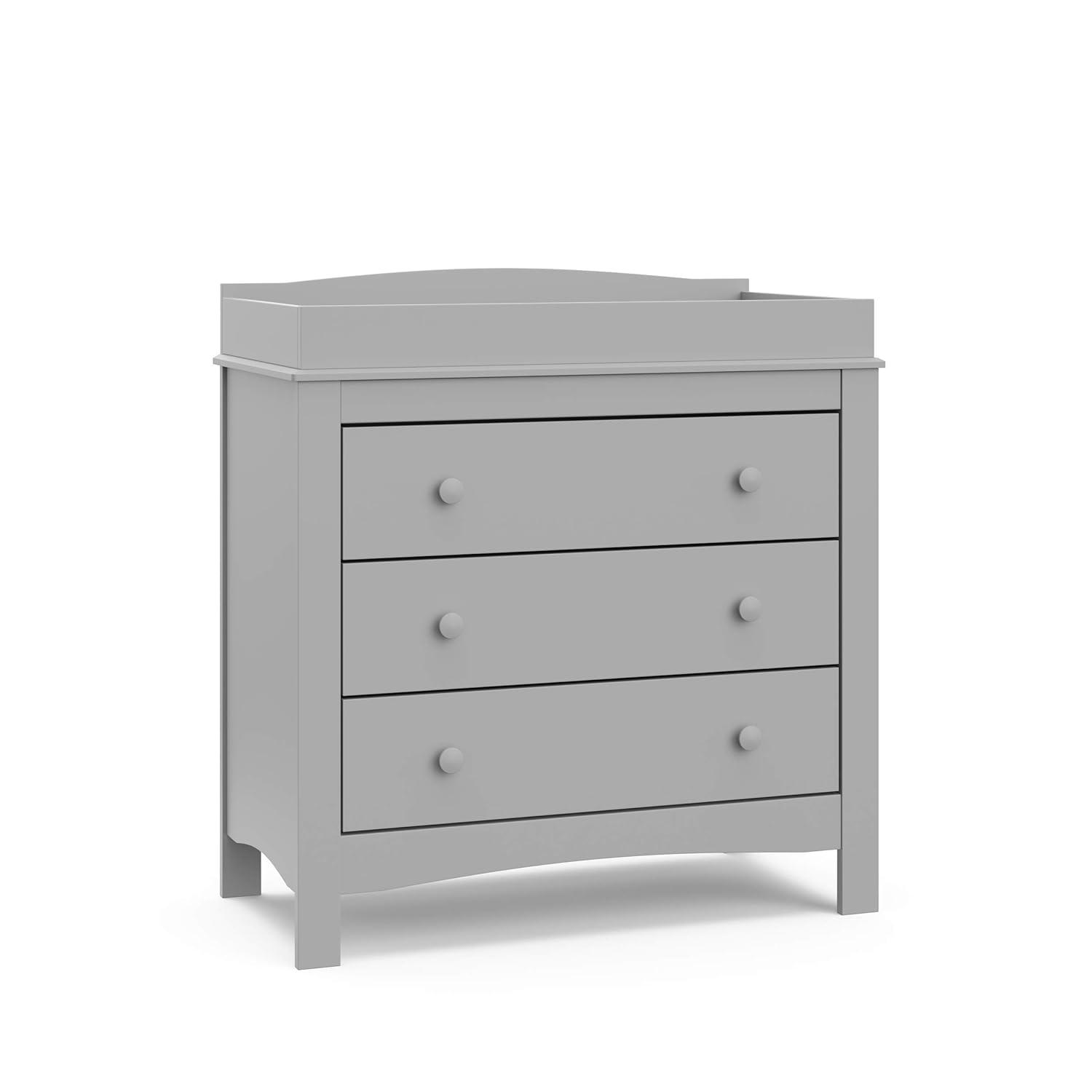 imageGraco Noah 3 Drawer Changing Table Dresser White GREENGUARD Gold Certified Baby Dresser with Changing Table Top Includes Interlocking Drawer SystemPebble Gray