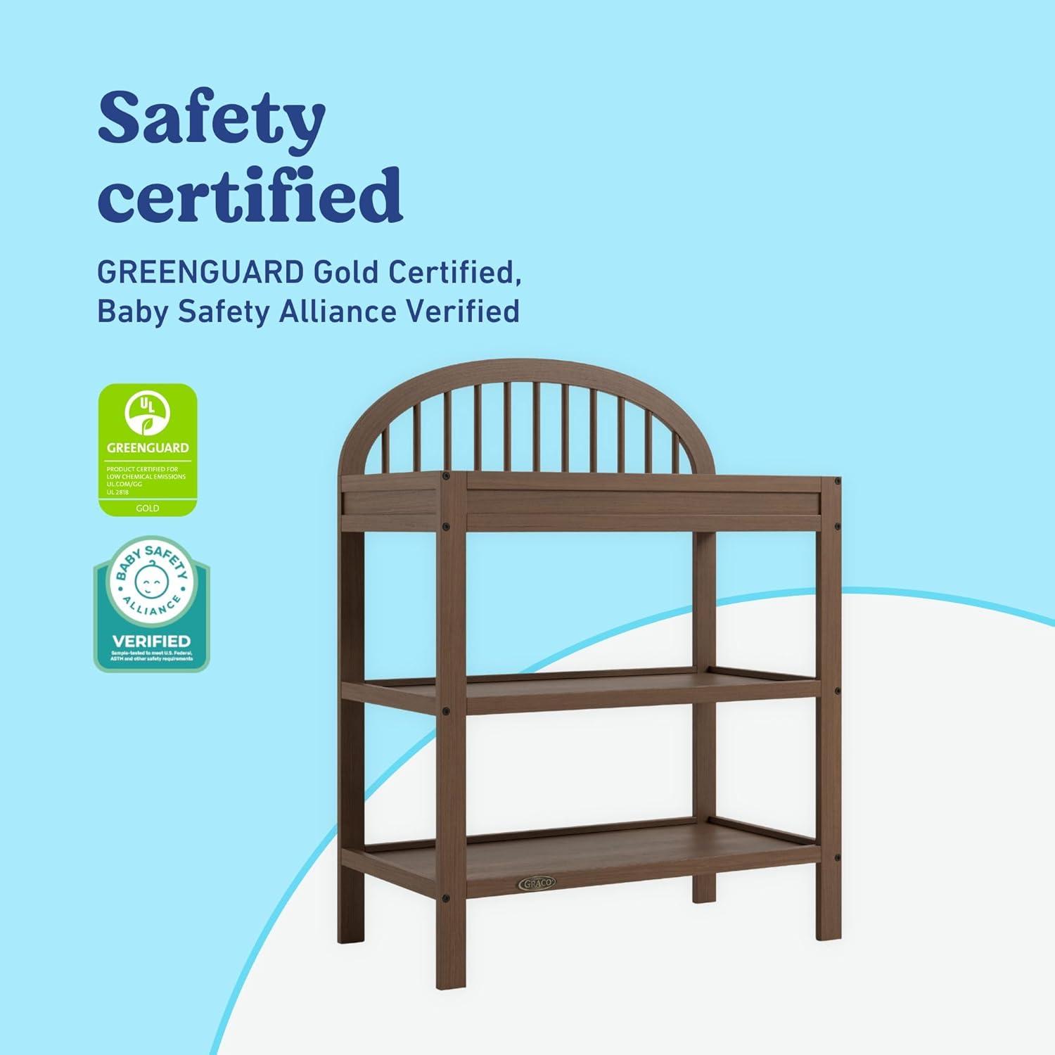 imageGraco Olivia Changing Table with WaterResistant Changing Pad Driftwood GREENGUARD Gold Certified Includes Bonus WaterResistant Changing Pad with Safety Strap 2 Open Shelves Stylish DesignHazelnut