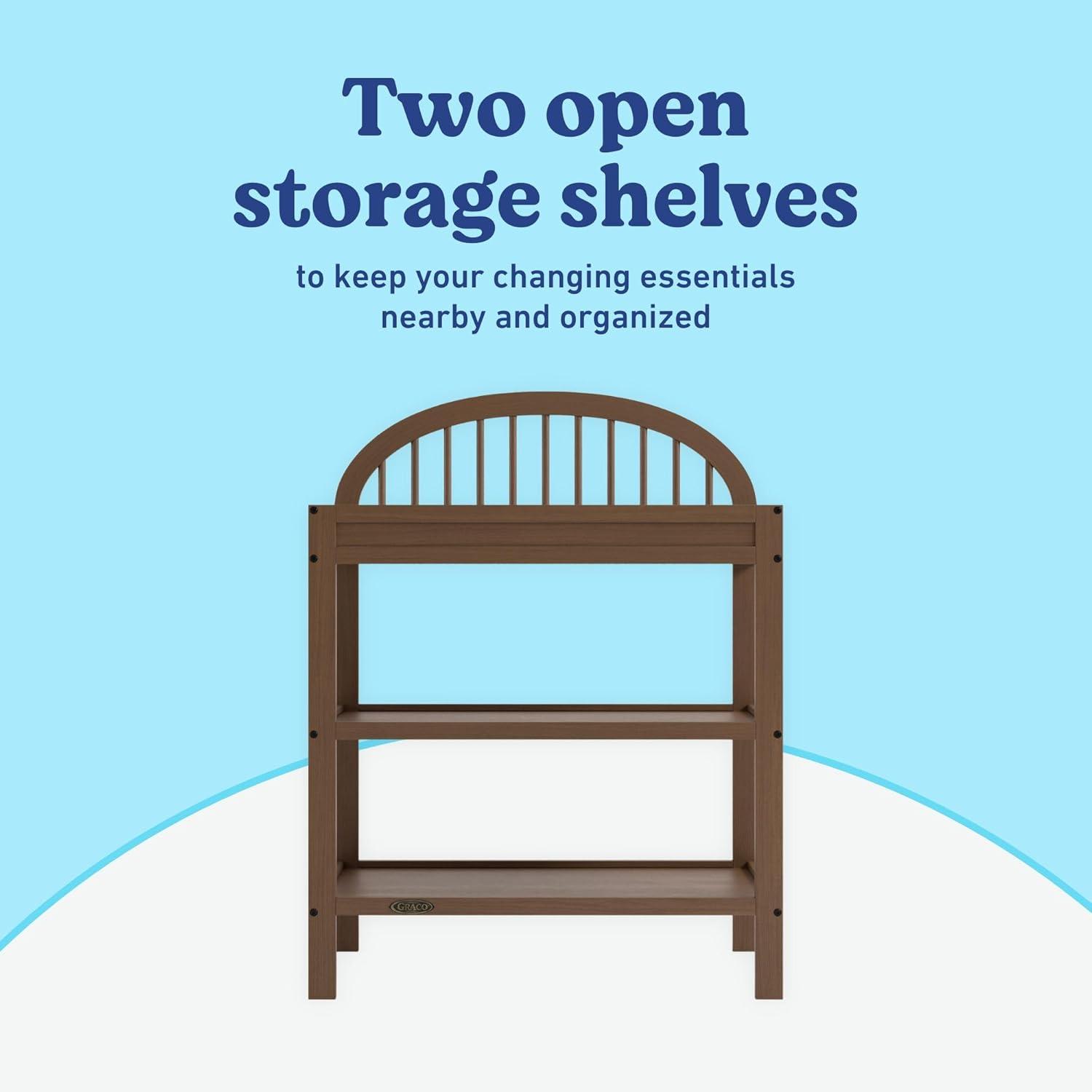 imageGraco Olivia Changing Table with WaterResistant Changing Pad Driftwood GREENGUARD Gold Certified Includes Bonus WaterResistant Changing Pad with Safety Strap 2 Open Shelves Stylish DesignHazelnut