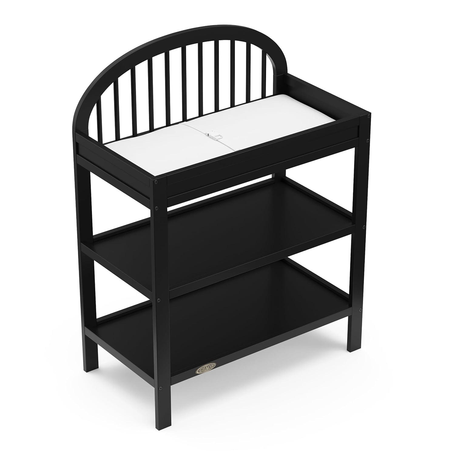 imageGraco Olivia Changing Table with WaterResistant Changing Pad Driftwood GREENGUARD Gold Certified Includes Bonus WaterResistant Changing Pad with Safety Strap 2 Open Shelves Stylish DesignBlack