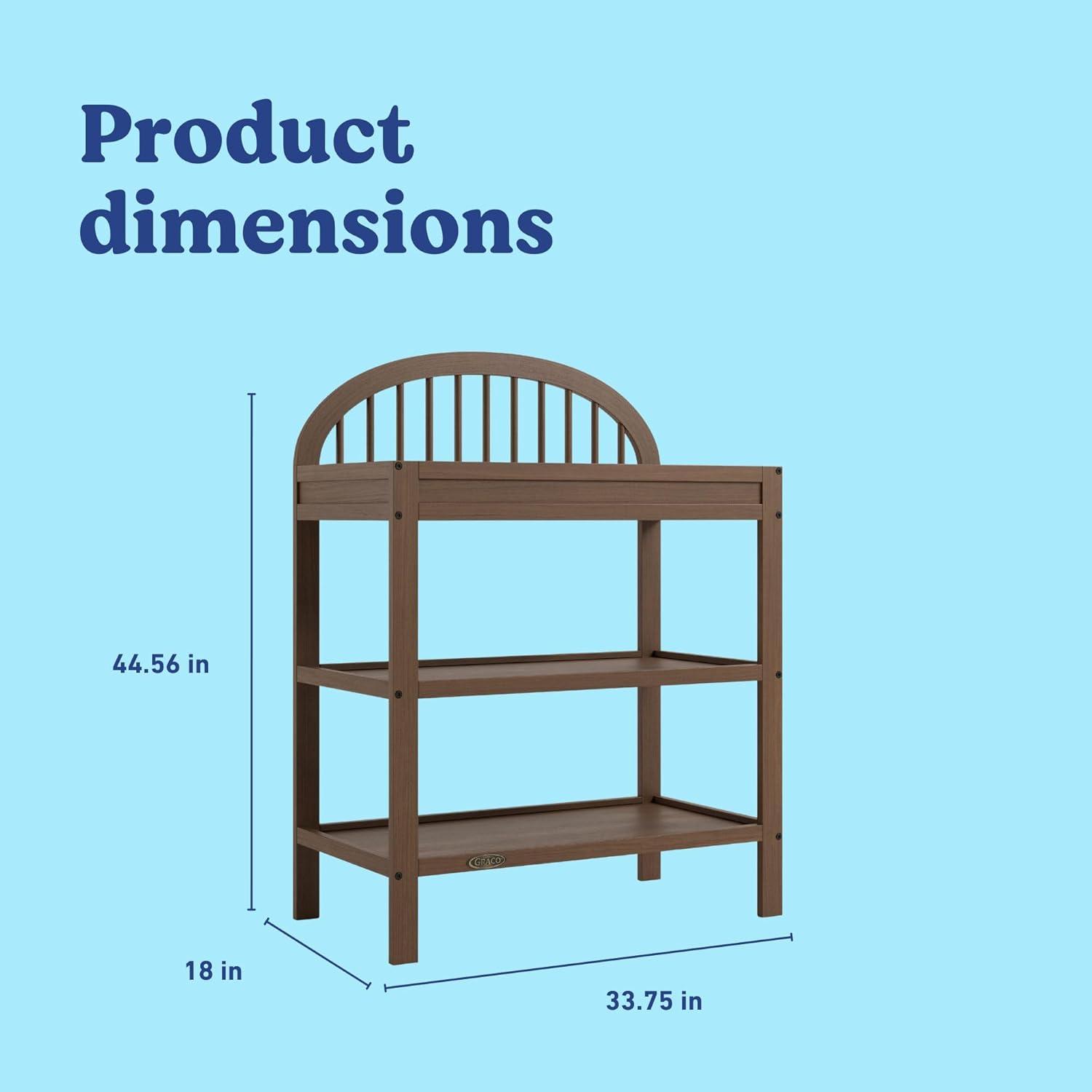 imageGraco Olivia Changing Table with WaterResistant Changing Pad Driftwood GREENGUARD Gold Certified Includes Bonus WaterResistant Changing Pad with Safety Strap 2 Open Shelves Stylish DesignHazelnut