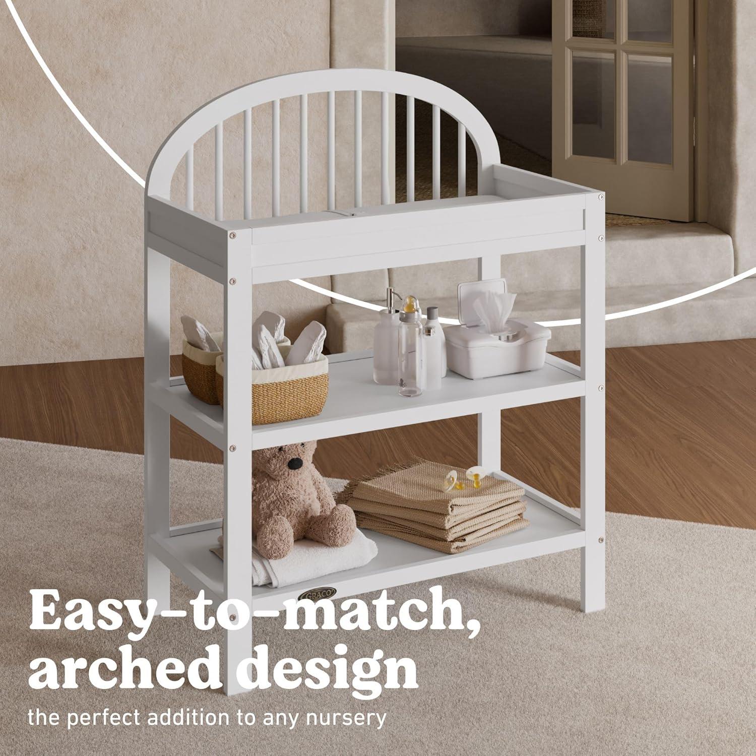 imageGraco Olivia Changing Table with WaterResistant Changing Pad Driftwood GREENGUARD Gold Certified Includes Bonus WaterResistant Changing Pad with Safety Strap 2 Open Shelves Stylish DesignWhite