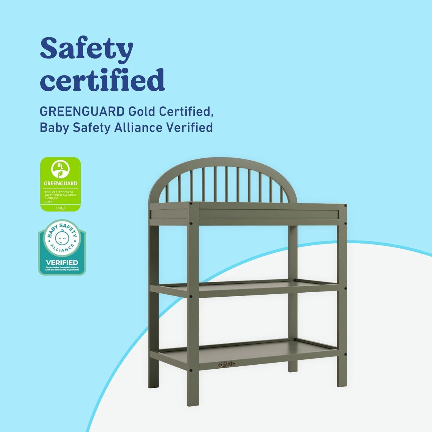 imageGraco Olivia Changing Table with WaterResistant Changing Pad Driftwood GREENGUARD Gold Certified Includes Bonus WaterResistant Changing Pad with Safety Strap 2 Open Shelves Stylish DesignOlive