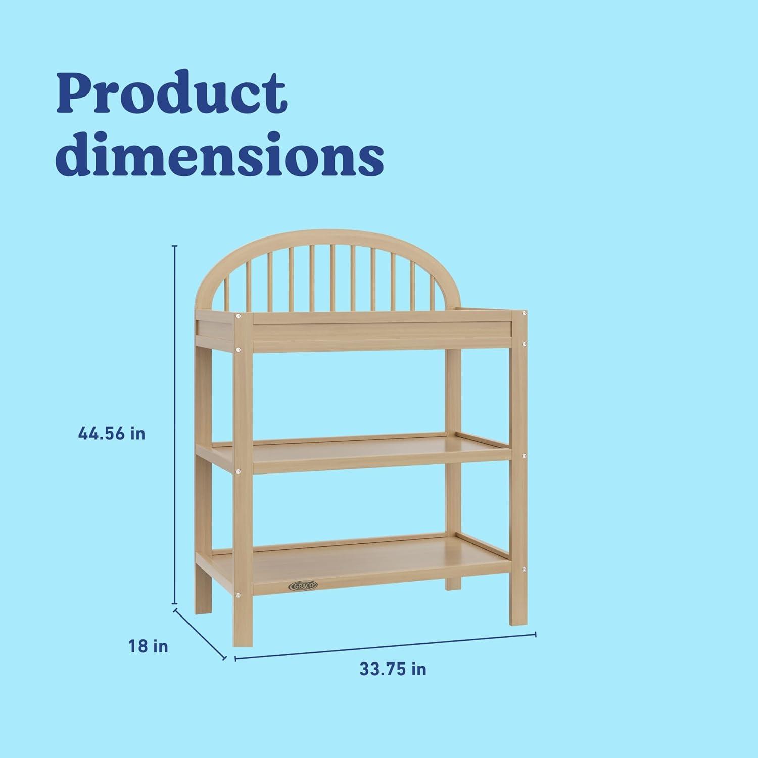 imageGraco Olivia Changing Table with WaterResistant Changing Pad Driftwood GREENGUARD Gold Certified Includes Bonus WaterResistant Changing Pad with Safety Strap 2 Open Shelves Stylish DesignDriftwood