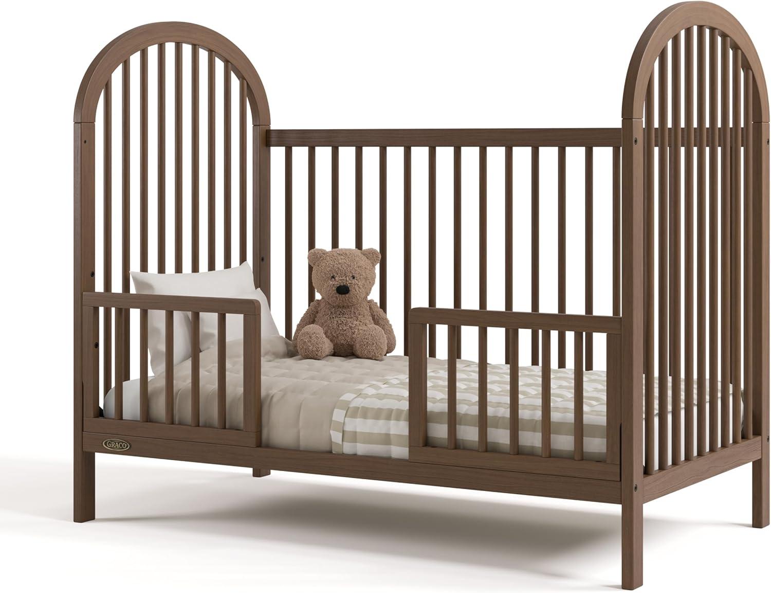 imageGraco Olivia Convertible Crib White GREENGUARD Gold Certified 100 Solid Wood Fits Standard Crib Mattress Converts to Toddler Bed and Daybed 4 Adjustable Mattress HeightsHazelnut