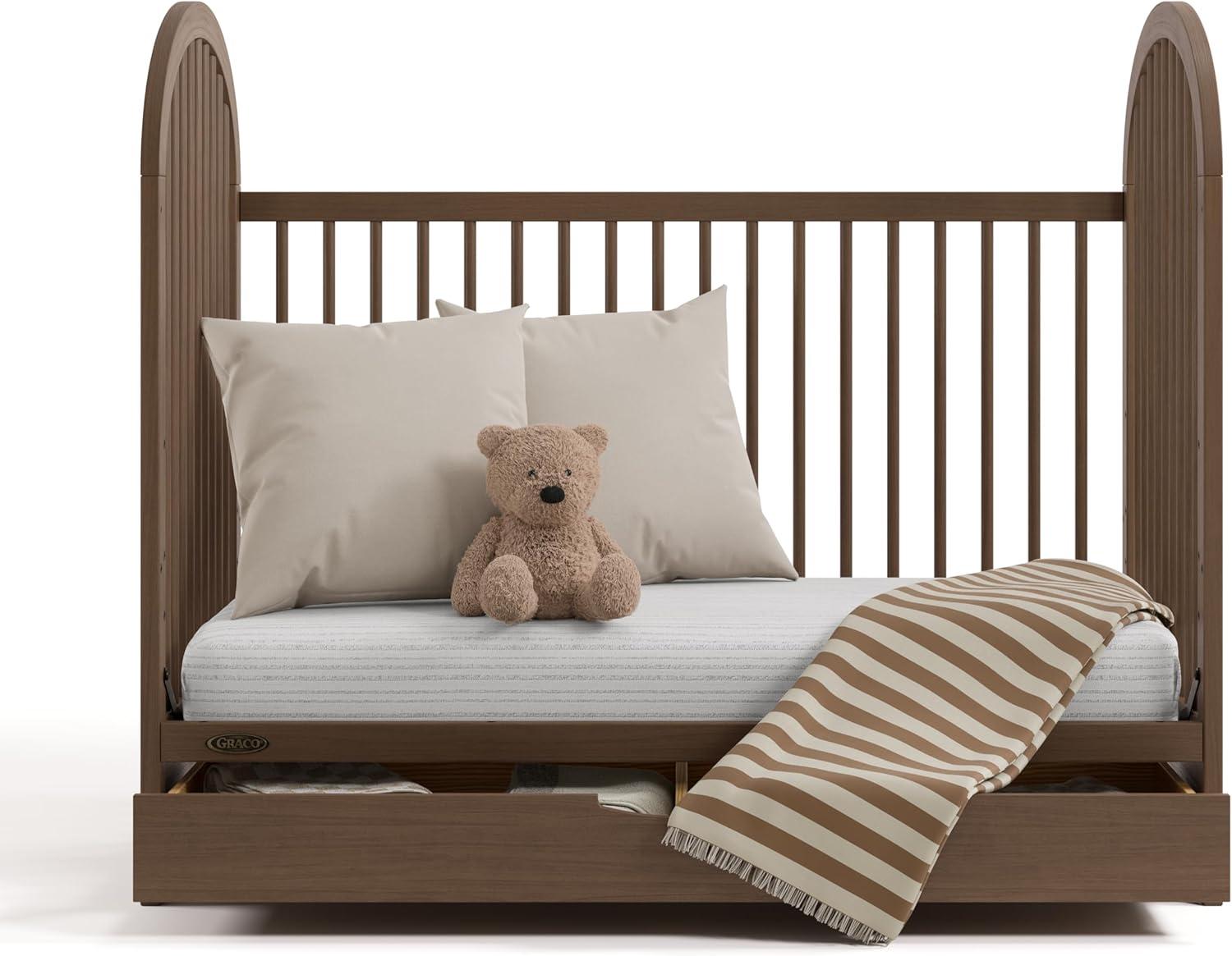 imageGraco Olivia Convertible Crib White GREENGUARD Gold Certified 100 Solid Wood Fits Standard Crib Mattress Converts to Toddler Bed and Daybed 4 Adjustable Mattress HeightsHazelnut