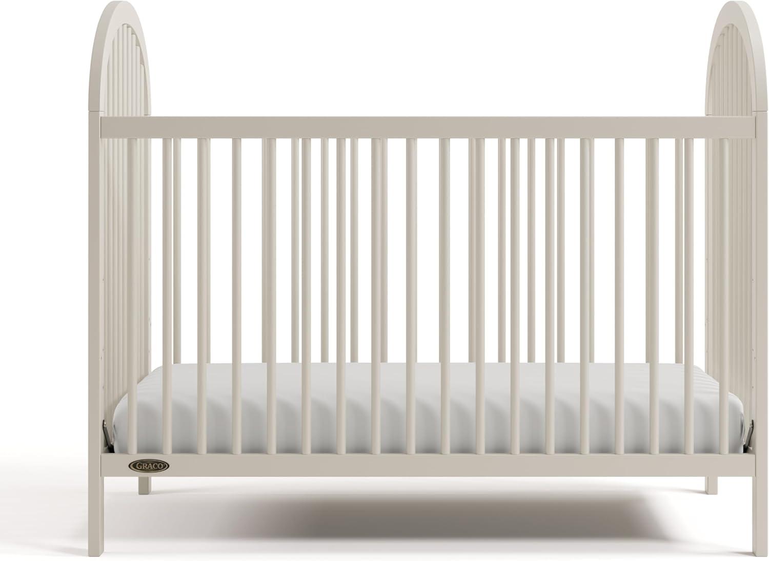 imageGraco Olivia Convertible Crib White GREENGUARD Gold Certified 100 Solid Wood Fits Standard Crib Mattress Converts to Toddler Bed and Daybed 4 Adjustable Mattress HeightsFrosted Oat