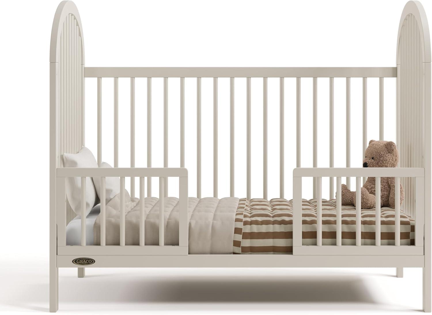 imageGraco Olivia Convertible Crib White GREENGUARD Gold Certified 100 Solid Wood Fits Standard Crib Mattress Converts to Toddler Bed and Daybed 4 Adjustable Mattress HeightsFrosted Oat