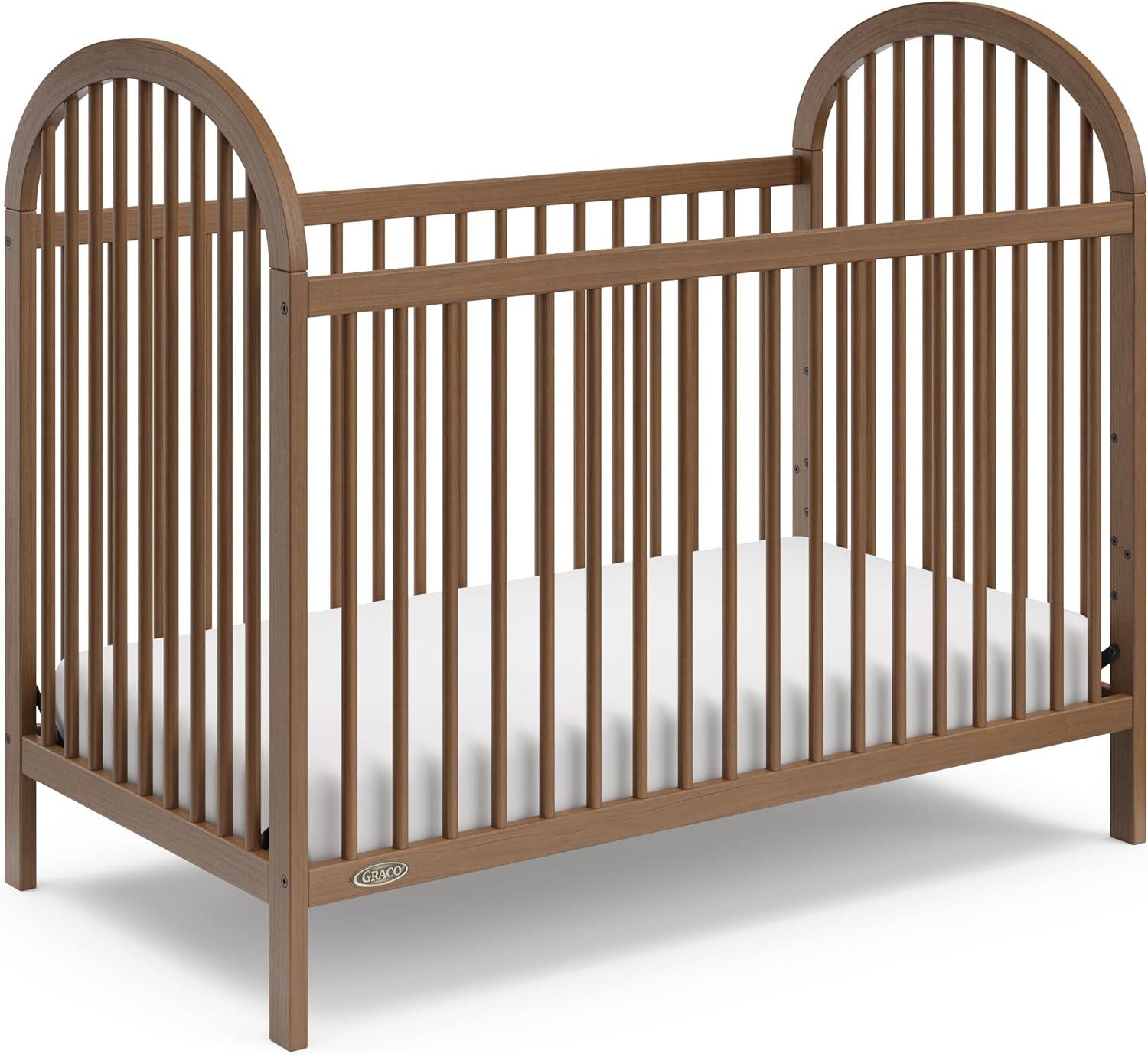 imageGraco Olivia Convertible Crib White GREENGUARD Gold Certified 100 Solid Wood Fits Standard Crib Mattress Converts to Toddler Bed and Daybed 4 Adjustable Mattress HeightsHazelnut