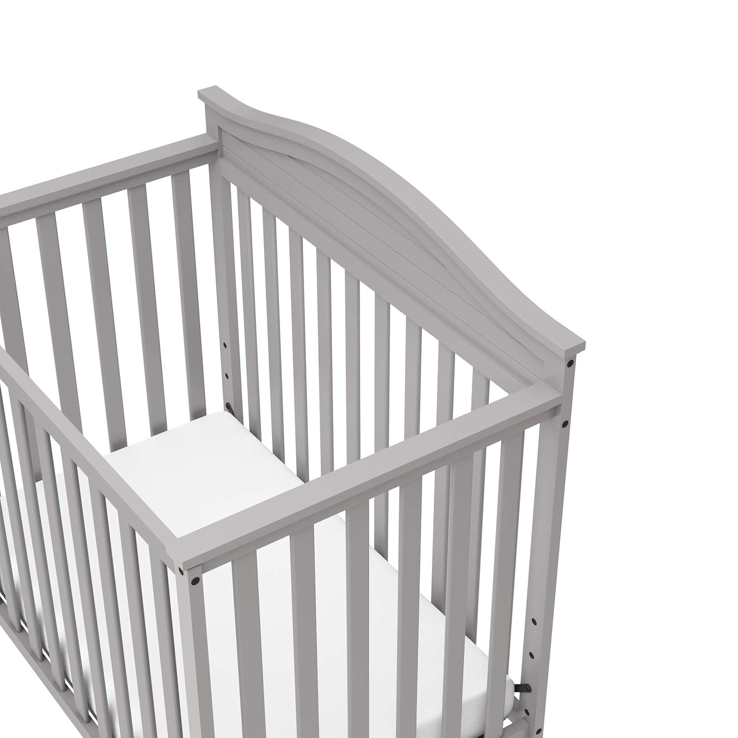 imageGraco Stella 4in1 Convertible Mini Crib with Bonus Mattress White Includes Bonus 275 Inch Thick Mattress with WaterResistant Cover Converts to Twin Bed Ideal Crib for Small SpacesPebble Gray