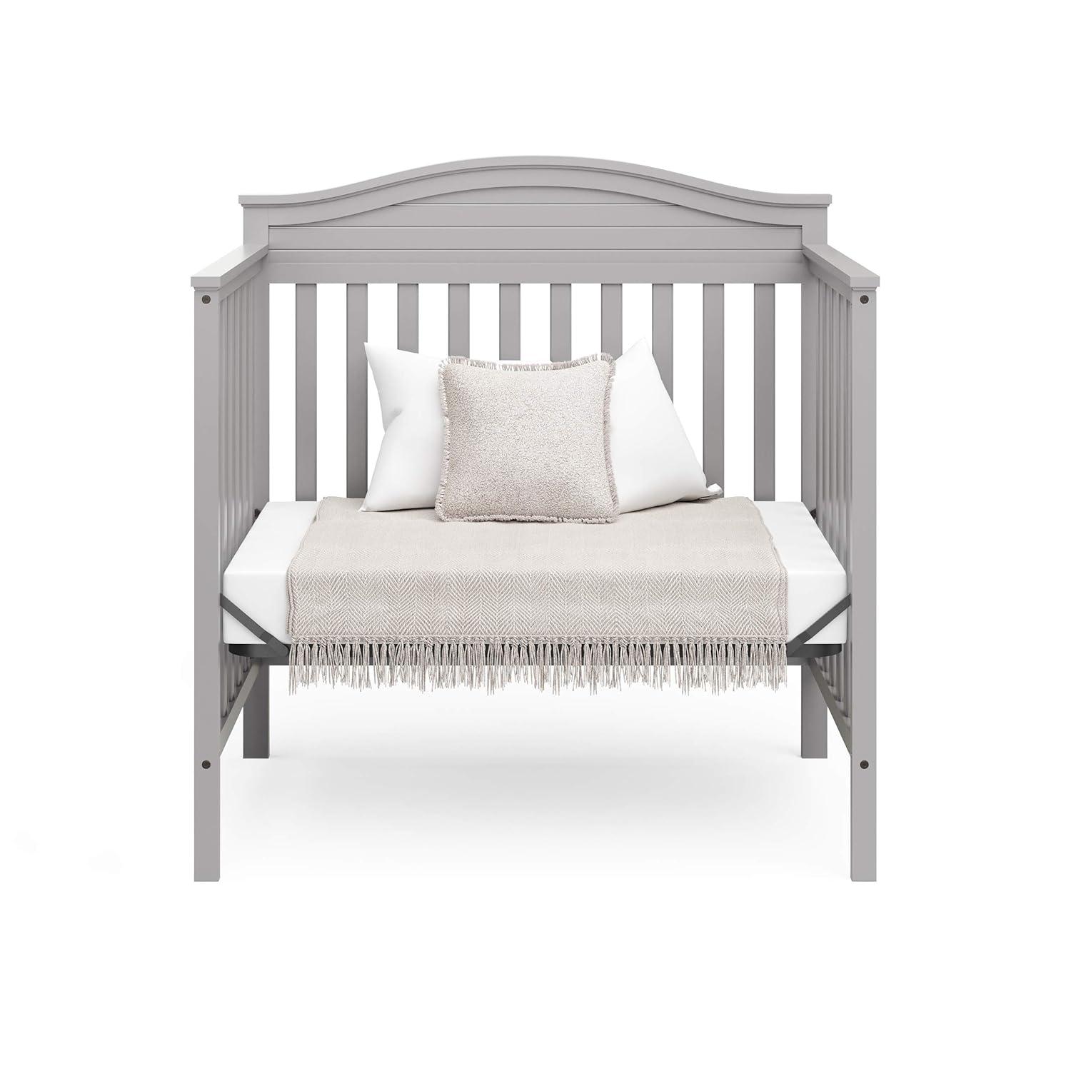 imageGraco Stella 4in1 Convertible Mini Crib with Bonus Mattress White Includes Bonus 275 Inch Thick Mattress with WaterResistant Cover Converts to Twin Bed Ideal Crib for Small SpacesPebble Gray