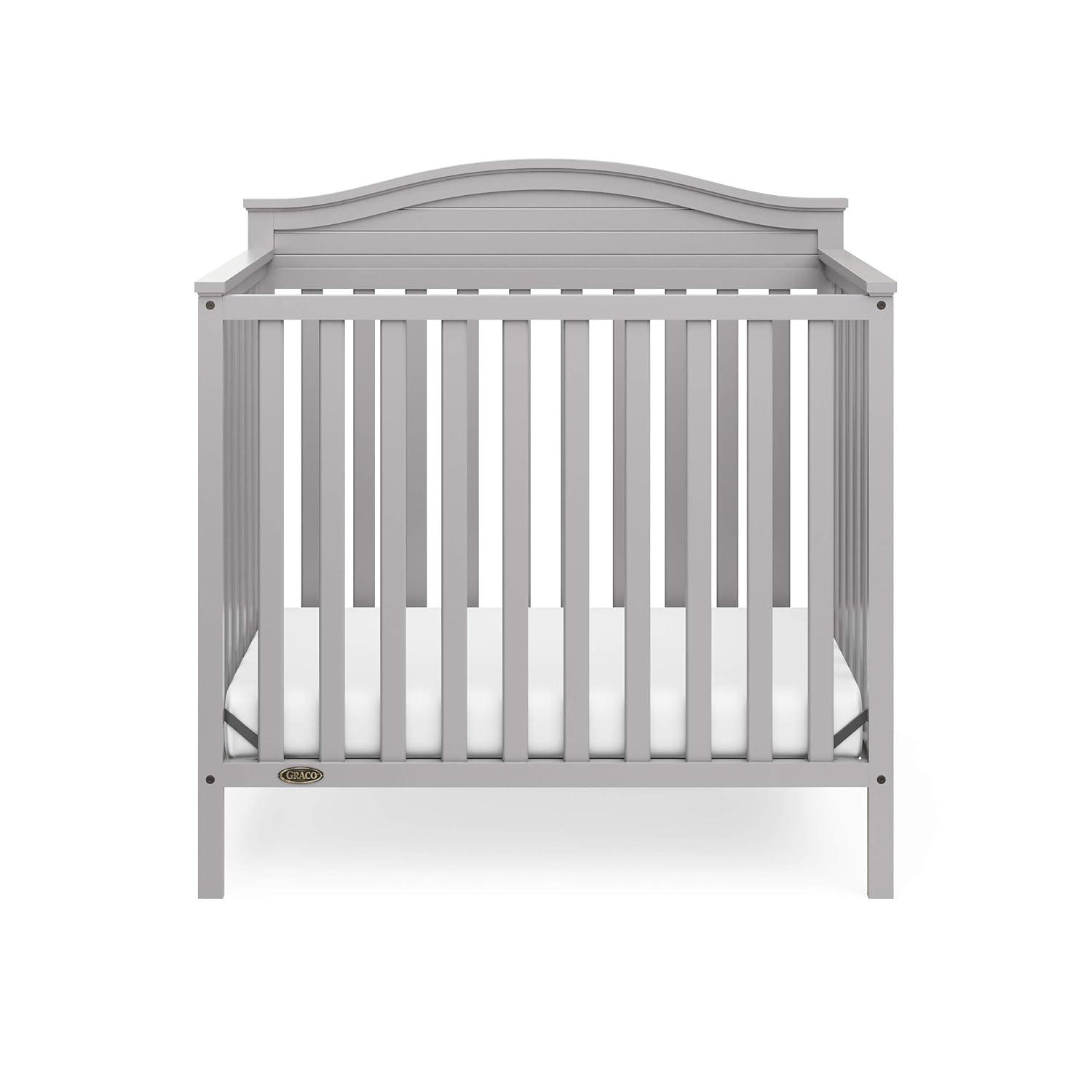 imageGraco Stella 4in1 Convertible Mini Crib with Bonus Mattress White Includes Bonus 275 Inch Thick Mattress with WaterResistant Cover Converts to Twin Bed Ideal Crib for Small SpacesPebble Gray