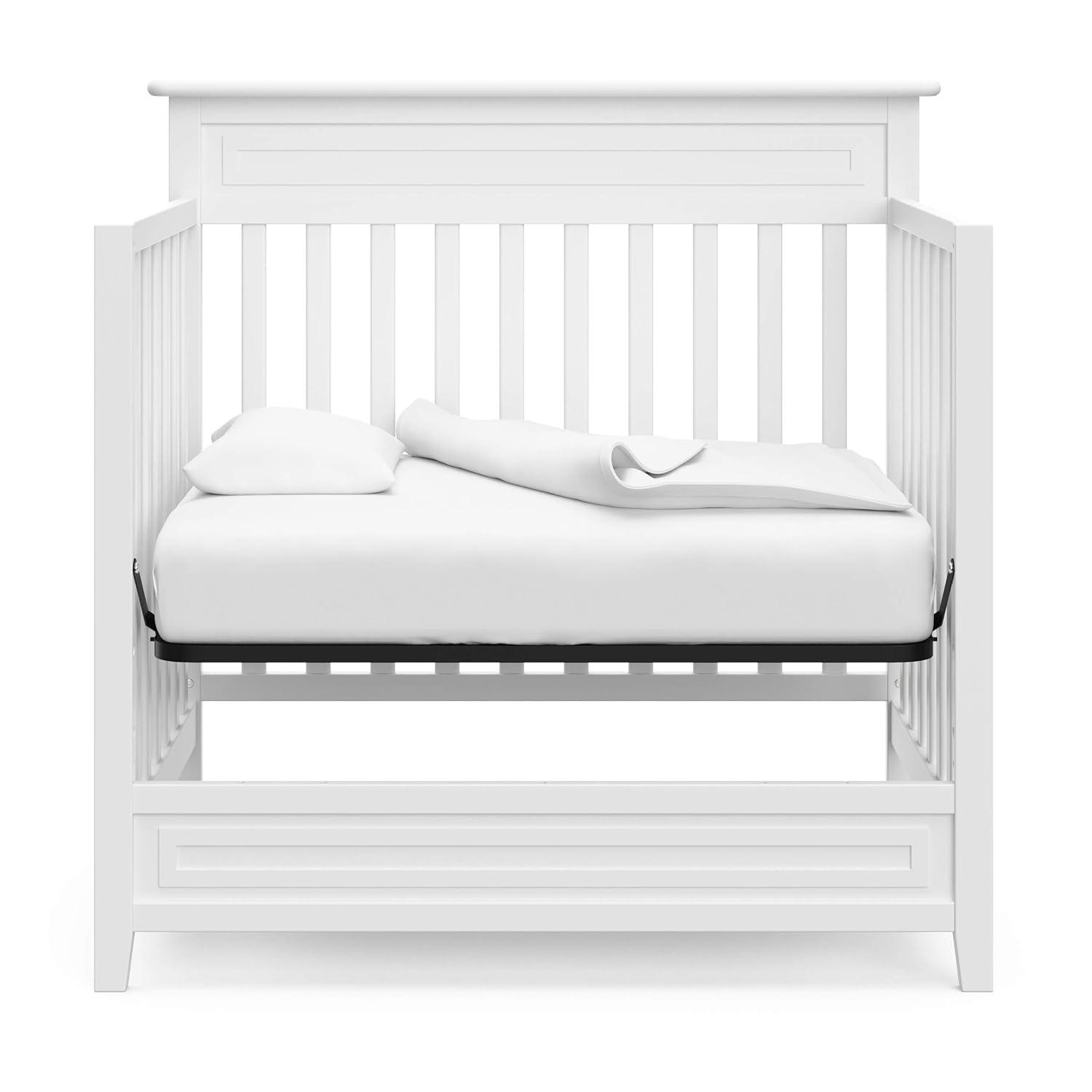 imageStorkcraft Petal 4in1 Convertible Mini Crib White GREENGUARD Gold Certified Converts to Daybed and TwinSize Bed Bonus 275inch Mini Crib Mattress Included Ideal for Small SpacesWhite