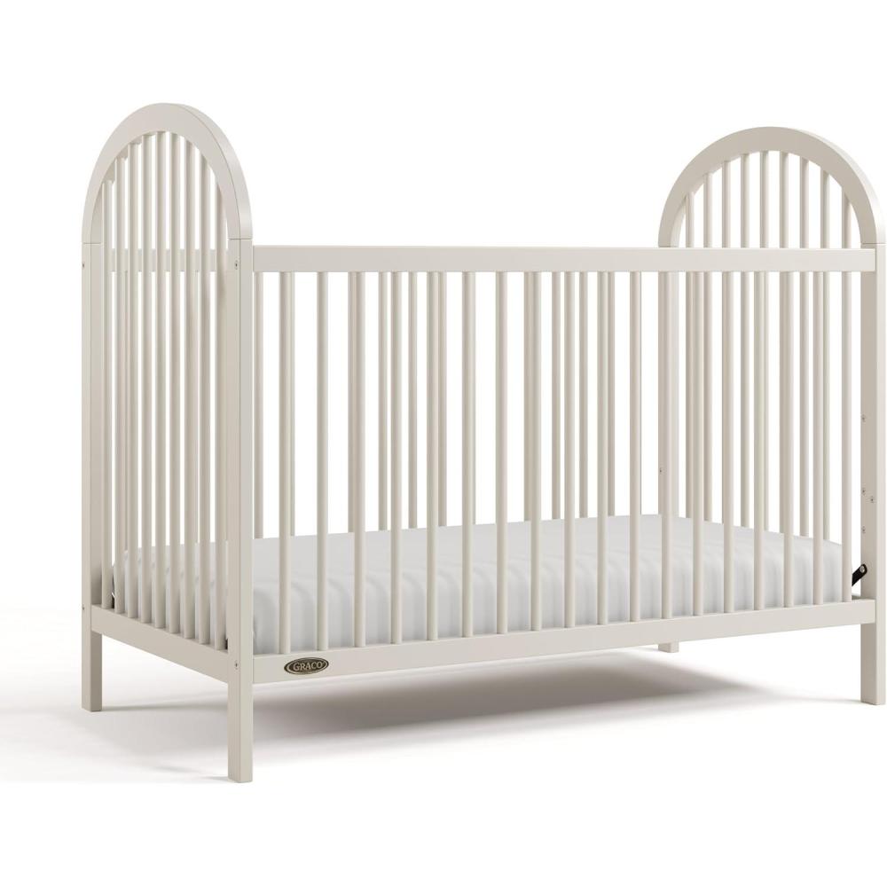 imageGraco Olivia Convertible Crib White GREENGUARD Gold Certified 100 Solid Wood Fits Standard Crib Mattress Converts to Toddler Bed and Daybed 4 Adjustable Mattress HeightsFrosted Oat